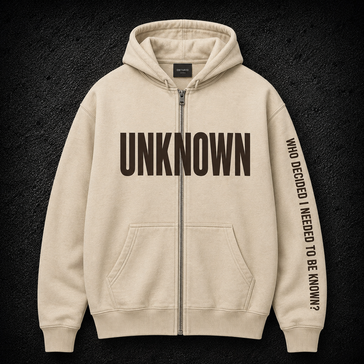 Bone zip hoodie with UNKNOWN chest print and a pixel-dissolved figure across the back
